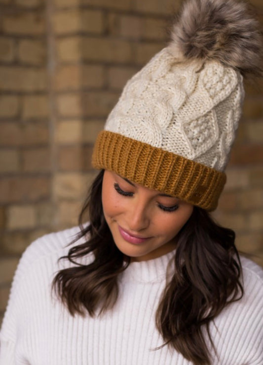 IVORY CABLE KNIT HAT WITH CAMEL CUFF AND FUR POM